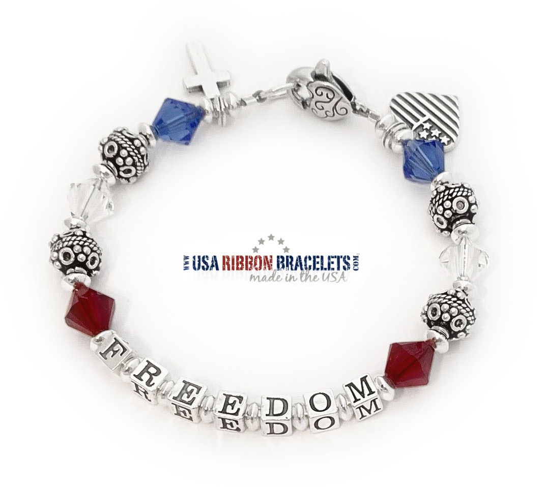 Handmade Red, White & Blue Bracelet – Faith & Freedom Design Handmade sterling silver Freedom bracelet with red, white, and blue Swarovski crystals, cross charm, and USA heart flag charm.